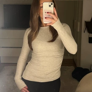 Stickad tröja - Beige långärmad stickad tröja med slim passform. Tröjan är enkel och stilren och har en detalj på sidan som gör den lite mer speciell. Tröjan är i mycket bra skick. 💓