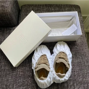 Maison Margiela beige sneakers i linne - Maison Margiela sneakers i beige linne med råa kanter och snygga detaljer. Skorna har snörning, platt sula och rund tå. Perfekt för dig som gillar en unik och trendig look. Kommer med originalkartong och dustbags. Äktahets bevis finns