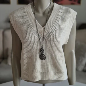 Slipover * stl S * Ärmlös v-ringad * naturvit - * V-ringad slipover  * Har även en grå på annons. * Stl S. * Perfekt att kombinera med en skjorta eller blus under. * Bröst: 49 cm mätt armhåla till armhåla * Nacke till ryggslut: 48 cm * Mycket bra skick. Hittar inga fel.  Djur och rökfritt hem. Se bilder och förstora då de ingår i beskrivningen. Se gärna mina övriga annonser.   Vid avhämtning finns den i Sollentuna.