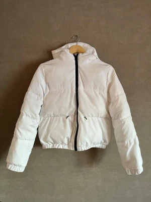 Vit pufferjacka från H&M - Säljer en snygg vit pufferjacka från H&M i storlek XS. Perfekt för kalla dagar💞