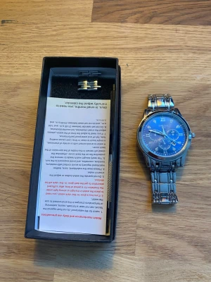 Herrklocka Orrus 1853 - En herrklocka från märket oruss 1853 i nytt skick med låda