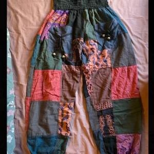 Hippie byxor i bomull - Färgglada hippie/boho byxor i 100% bomull. Byxorna har midja med resår och fickor framtill. Köpte dem för 350 kr och har endast använt en gång. Passar både S och M
