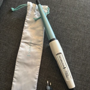Locktång  - Remington Shine Therapy Curling Wand med keramisk beläggning för skonsam styling.13-25 mm och har   Konisk design med snabb uppvärmning, temperaturinställningar upp till 210°C.