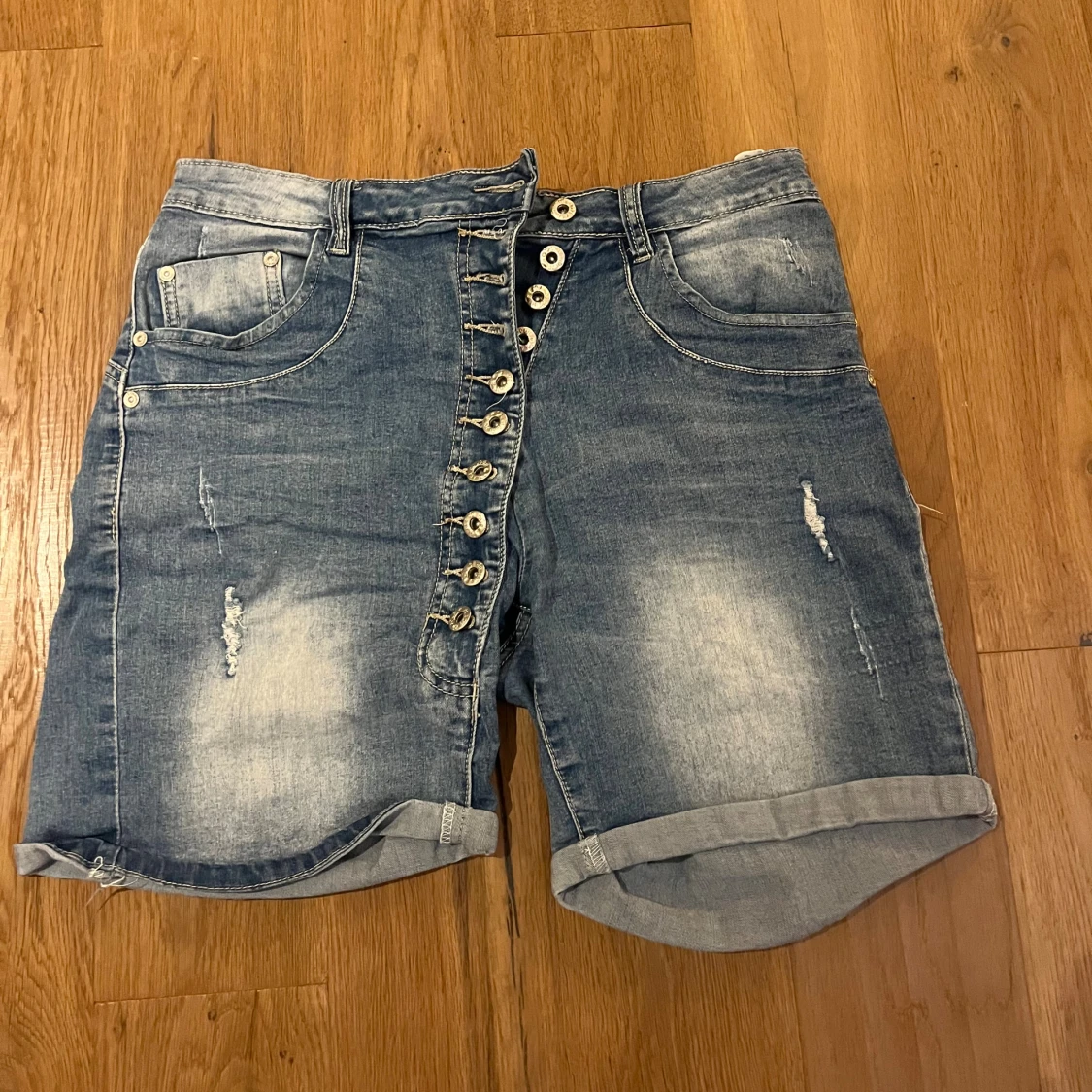 Blå denimshorts med knappar