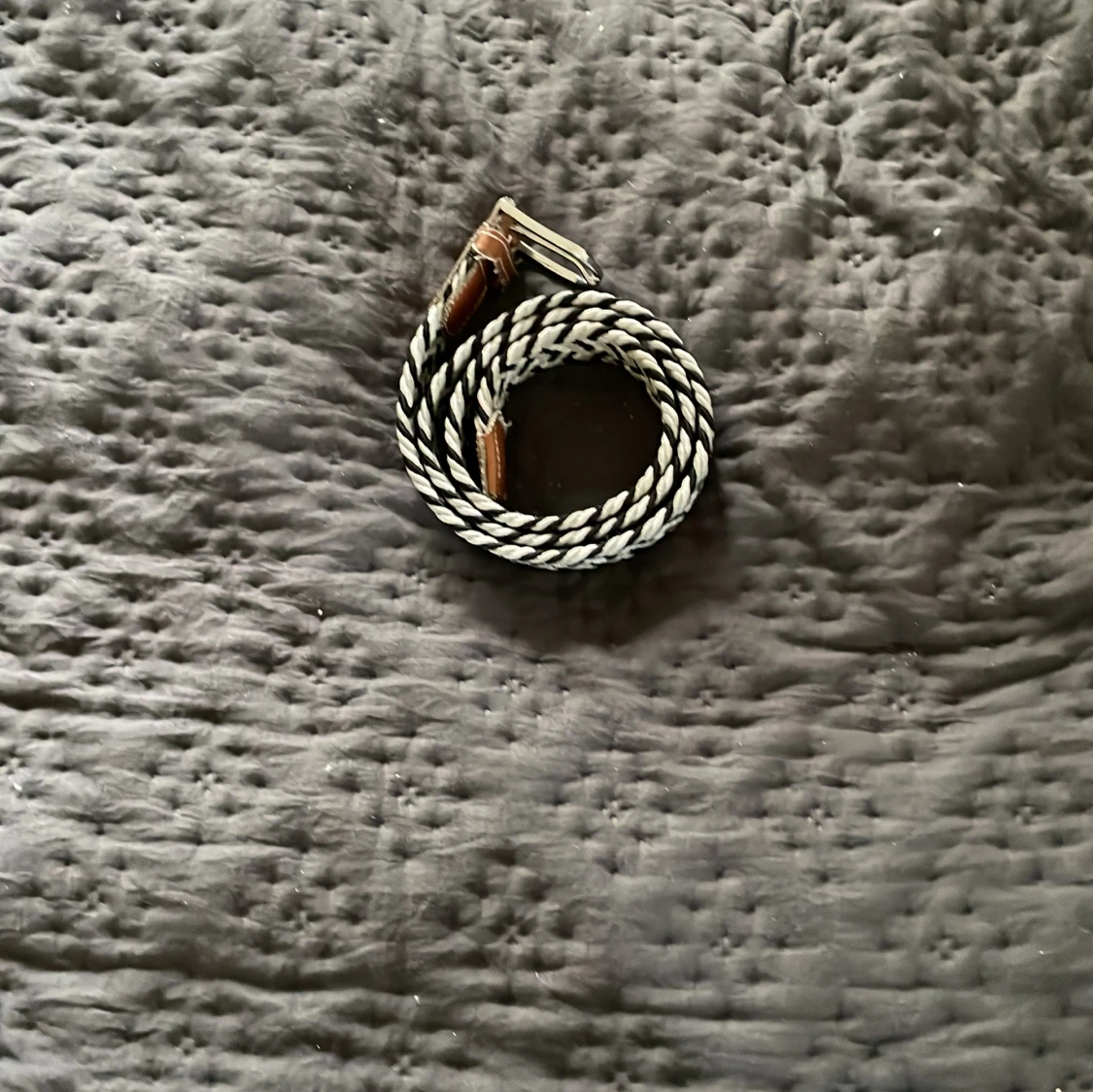 Randigt flätat bälte med läderdetaljer