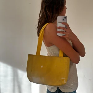 Gul axelväska från Birgitta - Säljer en solgul axelväska från Birgitta med rejäla axelband och rymligt fack. Är lite smutsig, men har tyvärr varken tid eller ork att tvätta den. Men är säker på att det går bort i tvätten. 💛