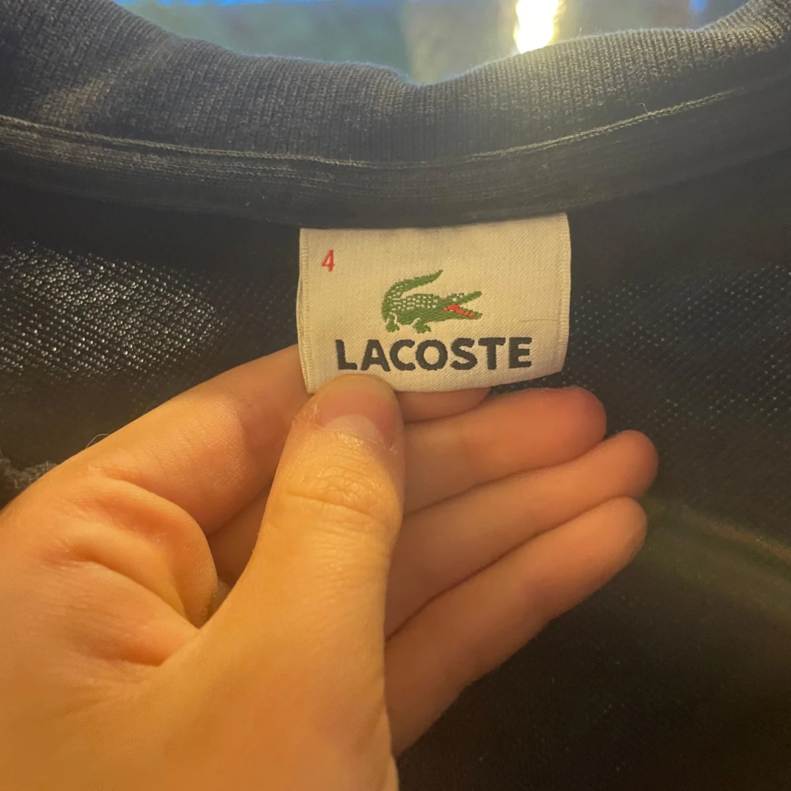 Svart pikétröja från Lacoste