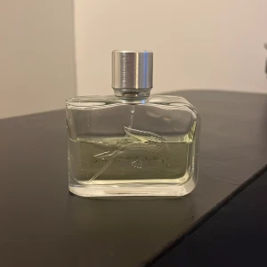 Lacoste parfym - En klassisk Lacoste parfym med den ikoniska krokodilen på flaskan. Perfekt för dig som gillar en sportig och modern stil. Volym och ingredienser syns ej på bilden.