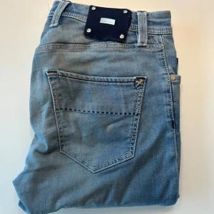 Ljusblå jeansbyxor från Tramarossa - Snygga ljusblå jeansbyxor från Tramarossa med klassisk femficksdesign och silverfärgade detaljer. Jeansen har raka ben och slim passform, perfekt för en avslappnad stil. Tillverkade i mjukt denimtyg för skön känsla hela dagen. OBS! Hål i framfickorna intuti men det är en Easy fix!