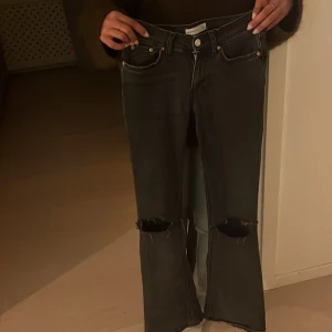 Svarta bootcut Lågmidjade  jeans med hål - Säljer ett par svarta bootcut jeans från Perfect Jeans i storlek 32. Jeansen har stora slitningar vid knäna och är Lågmidjade pris kan absolut diskuteras ❤️❤️och jeansen har inga synliga defekter 