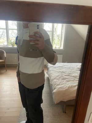 Randig pikétröja från Bondelid - Säljer en snygg pikétröja från Bondelid i storlek S. Tröjan har breda beige och vita ränder, klassisk krage och knappar vid halsen. Materialet är mjuk bomull och passformen är normal. Perfekt för dig som gillar stilrena och chill plagg.