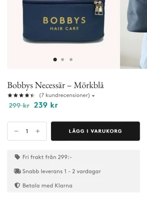 Mörkblå necessär från Bobbys - Snygg och rymlig mörkblå necessär från Bobbys Hair Care i veganskt läder. Perfekt för att förvara dina skönhetsprodukter, med ett stort handtag och fuktavvisande material som är lätt att rengöra. Guldigt tryck på framsidan och dubbla dragkedjor. Helt ny inplastad 