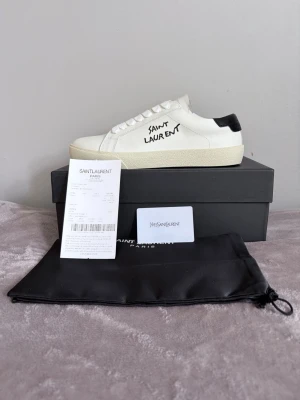 Saint Laurent vita sneakers - Säljer ett par vita Saint Laurent skor! De är helt perfekta till sommaren och storlek 42! Skorna är i nytt skick och allt og medkommer vid beställning! Hör av er vid minsta fundering! Mvh Quadra Closet!