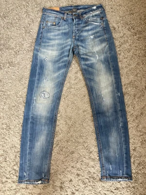 Dondup Blå slitna jeans  - Säljer ett par Dondup blå jeans med slitningar                         Märke - Dondup                                                                     Storlek - 31                                                                          Skick - 9/10  