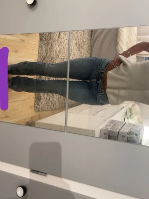 Blå bootcut jeans med broderad ficka - Säljer ett par blåa bootcut jeans med snygg broderad bakficka och klassisk femficksmodell. Jeansen har en något utsvängd passform och är tillverkade i denim med en cool tvätt. Använt Max 4 gånger 