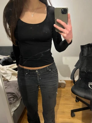 Svart långärmad croppad topp - Säljer en svart långärmad croppad topp med rund halsringning. Toppen har en tight passform