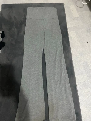 Gråa yoga pants Gina Tricot - Snygga grå yoga pants från Gina Tricot med  hög midja. Mjukt och stretchigt material som sitter skönt hela dagen. Perfekta att matcha med en oversized hoodie eller crop top för en chill look.