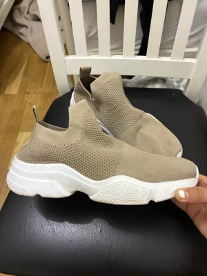 Beigea sneakers från Lager 157, storlek 39 - Dessa beigea sneakers från Lager 157 har en stickad ovandel och en tjock vit sula. Storlek 39.  Mycket bra skick.