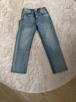 Ljusblå raka jeans - Säljer ett par ljusblå jeans med rak passform och klassisk femficksdesign. 