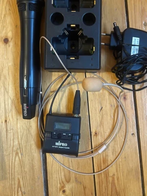 Mipro trådlöst mikrofonsystem - Säljer ett komplett trådlöst mikrofonsystem från Mipro med svart handhållen mikrofon, headset med beige mikrofon, bältespack och laddstation. Perfekt för presentationer, scenframträdanden eller undervisning. Inkluderar även strömadapter. Allt i robust plast och metall. Batteri saknas till ”sändaren”  annars i jättebra skick .