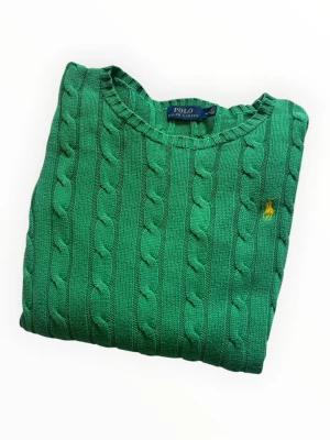 Grön kabelstickad Ralph Lauren - Grön ralph lauren tröja.  Fint skick (8/10)  Storlek: M  100% bomull   📐Mått:  Axedbredd: 46cm Längd: 57cm  DM vid funderingar 💕 Pris är ej huggen i sten. Kom gärna med bud.    Upp till 20% vid köp av bundles 