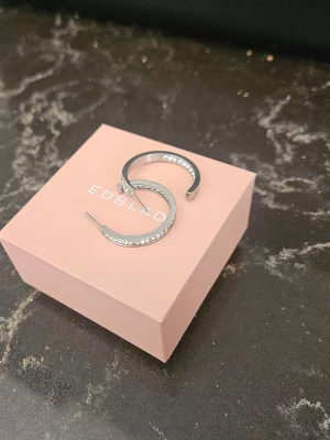 Edblad Monaco Earrings Small Silver - Edblad Monaco Earrings Small Silver i nyskick. Mått 27 mm. Kommer i ask och givetvis med bakstycken. För tydlighets skull togs dessa bort på bilden.