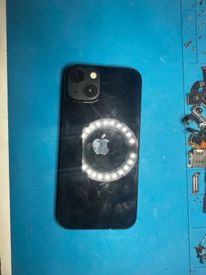 Svart iPhone med dubbla kameror - Säljer en svart iPhone med stilren glasbaksida och två kameror placerade i hörnet. Apple-loggan syns tydligt på baksidan. Telefonen har rundade hörn och en modern design som känns riktigt fräsch. Perfekt för dig som gillar snygg och funktionell teknik.