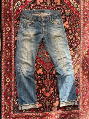 Nudie selvedge denim - Nudie selvedge jeans med vintage wash | Passform: Average Joe / straight fit | Storlek: W32 L36 | Längden på jeansen är 36 men eftersom man brukar vika upp selvedge jeans så blir det mer L34-35, passar mig som är 185cm perfekt. 