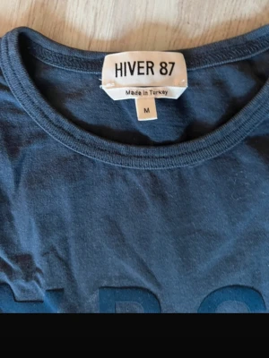 A. P. C T-shirt  - En enkel och stilren mörkblå t-shirt från A.P.C Klassisk rund halsringning och korta ärmar. Tillverkad i mjuk bomull som känns skön mot huden. Perfekt till jeans eller shorts för en avslappnad look.