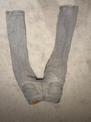 Gråa raka jeans från jack and Jones - Säljer ett par gråa jeans. W27-L32