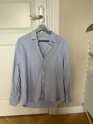 Blårandig Arket skjorta med knappar - Bårandig skjorta från arket med krage och knäppning. Endast använd ett fåtal gånger, mycket fint skick🤩