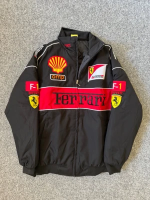 Ferrari black and red varsity jacket - Size M, true to size. Very comfortable and fits perfectly.