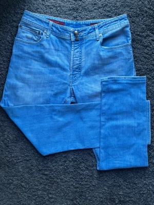 Jacob Cohën - Perfekt Ljus Sommartvätt | Premium J688 - Handgjorda  jeans från Veneto i Italien. Ljusblå tvätt med exklusiva detaljer som ger tydlig premiumkänsla. Skriv för fler bilder.  🧵 Märke & modell: Jacob Cohën J688 COMF. 📏 Storlek W36 men passar snarare W32. Modern slim (slim straight). 🧩 Stretchdenim: 92% bomull, 6% polyester, 2% elastan. 📐 Mått: A: 40 cm, B: 72 cm, C: 100 cm. ✅ Skick 8,5/10 . ✨ Handgjorda i Veneto, mönstrade fickpåsar, ”Type 688 C” vid gylfen och italiensk flagga. 💰 Nypris ca 4 500 kr.  ‼️Skickas samma dag/dagen efter‼️