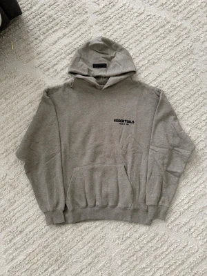 Essentials dark oatmeal hoodie - Size M, true to size. Unused, brand new and fresh. Please feel free to ask questions.