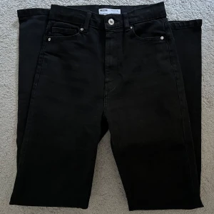 Svarta raka jeans från Bershka - Säljer ett par svarta jeans från Bershka med rak passform. Jeansen har hög midja och en slim fit. Storlek 36. Når precis till hälarna, jag är 164 cm lång. Använd 1-3ggr så inga tecken på användning.