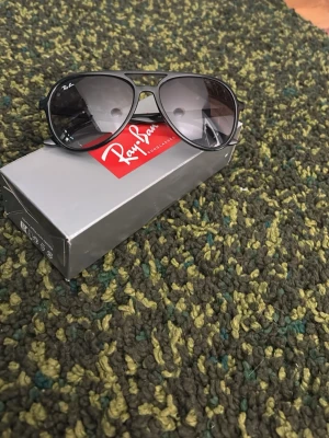 Rayban 4376 - Säljer dessa väldigt feta Raybans nu. De är pilotstil och passar bra nu till sommar. Storleken är 57, 16 btw. Själva glasögonen är i bra kondition men det svarta skalet har tre separata skador. Köpte de för typ 2000 säljer här för 400. Allt på bilderna ingår. Kontakta mig för mer info. 