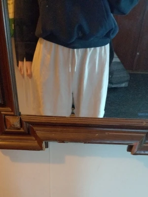 Beiga mjukisbyxor med dragsko - Säljer ett par beiga mjukisbyxor med resår i midjan och dragsko. Byxorna har avslappnad passform och är gjorda i mjukt tyg, perfekta för chill dagar. Inga synliga loggor eller märken. Passar dig som gillar enkel och clean stil.