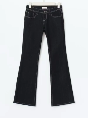 Mörkblå bootcut jeans med kontrastsömmar - Snygga mörkblåa bootcut jeans med vita kontrastsömmar och klassisk femficksdesign. Jeansen har låg midja och utsvängda ben, vilket ger en retroinspirerad look. Perfekta att styla med sneakers eller boots. Materialet är denim. Sprättat längst ner men inget som syns. Säljer pga kommer inte till använding