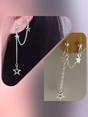By prisförslag- 1 st Silvrigt örhänge med kedja och stjärnor - Snyggt silvrigt örhänge med dubbla stift, kedja och tre stjärnberlocker. Ena stjärnan har ett utskuret mönster i mitten. Örhängena har en modern och edgy look, perfekta för att lyfta din stil. Materialet är metall i silverfärg.