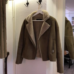 Mysig jacka till våren/hösten - Säljer denna jacka då den aldrig kommit till användning, den är i superfint skick. Det är brun mocka imitation med beiget fluff på insidan!