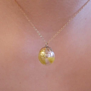 Handgjort halsband  - Handgjort halsband. Gul glaskula fäst i guldblad. 42 cm långt