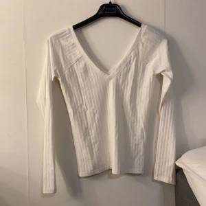 V-ringad topp, Bikbok, Strl M - Vit V-ringad topp. Passformen är tight