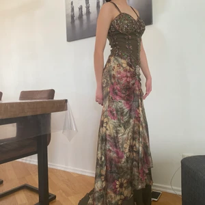 Balklänning i storlek S  - Super fin balklänning, helt ny, använd bara en gång, mörk gröna klänningstyg och blommig silk kjolen 