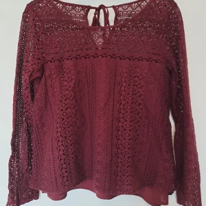 Blus Hollister  - En fin vinröd blus ifrån Hollister. Blusen har mycket fina spets detaljer och är i mycket bra skick. Nästan aldrig använd. Storleken är S och stämmer väldigt bra.