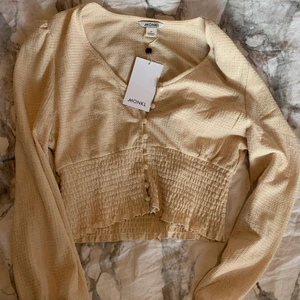 Monki blus M - Blus i storlek M från Monki, aldrig använd 💓 Den är ljusbeige och lite glittrig. Passar jättefint och är i fint material. Tveka inte att höra av dig om du har frågor eller vill ha fler bilder 🌟 FRAKT INKLUDERAD I PRISET!