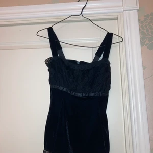 Svart sammets linne med spets detaljer. - Ett elegant svart topp med spetsdetaljer, orginal storlek var small men den är numera insydd till xs