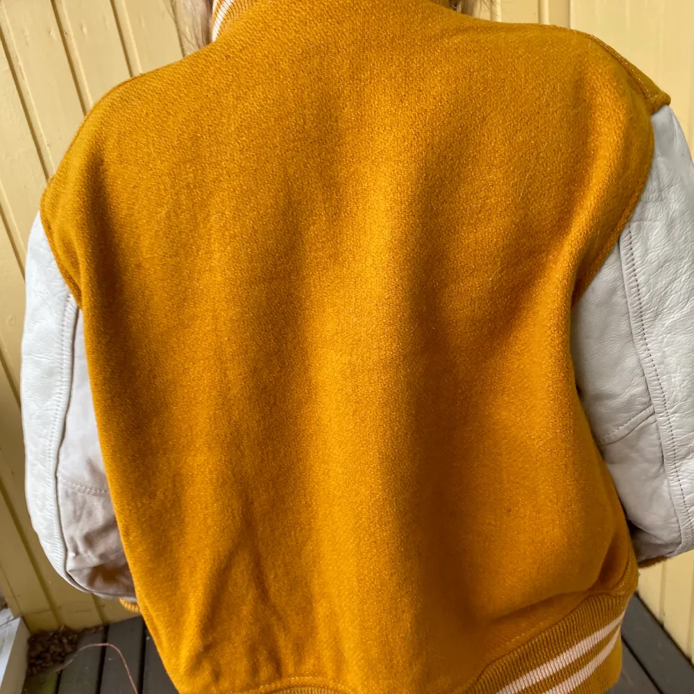 Yellow fabric with off white leather . Hoodies.