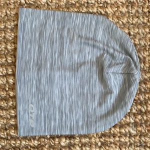 Löparmössa från OTP i mycket bra skick - Obs! Plagget är i något varmare grå än på bilden. Tunn löparmössa i mycket bra skick från OTP (gekås). Material: 90% polyester, 10% elastan. Hör av dig vid minsta fråga😃Köparen står för frakten!