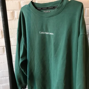 Calvin Klein Jeans collagetröja  - Ascool collagetröja från Calvin Klein. Kommer inte till användning:/fint skick! storlek S men rätt så oversize så passar upp till XL. Fin grön färg🥰buda i kommentarerna om fler är intresserade(börja på 200 och höj med 10) budgivning slutar på fredag 17:00🤝köpare betalar frakt📦
