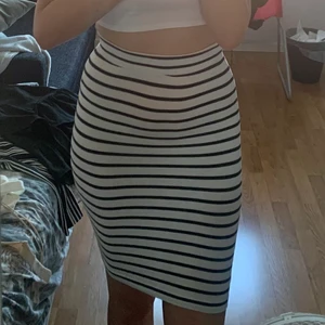 Randig pennkjol vit blå/svart storlek S - Randig pennkjol /kjol från JACQUELINEdeYONG. Storlek S (small). Vit och svarta/mörkblåa ränder. 95% bomull, 5% elastan. Frakt tillkommer.